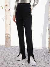 a woman in black flared pants